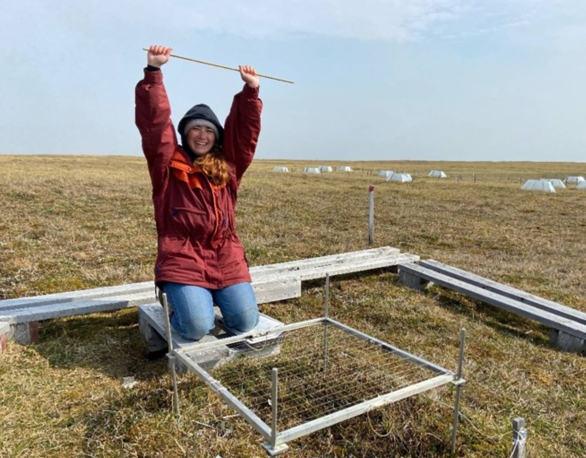 Emma celebrates a finished Point Frame plot in Utqiagvik